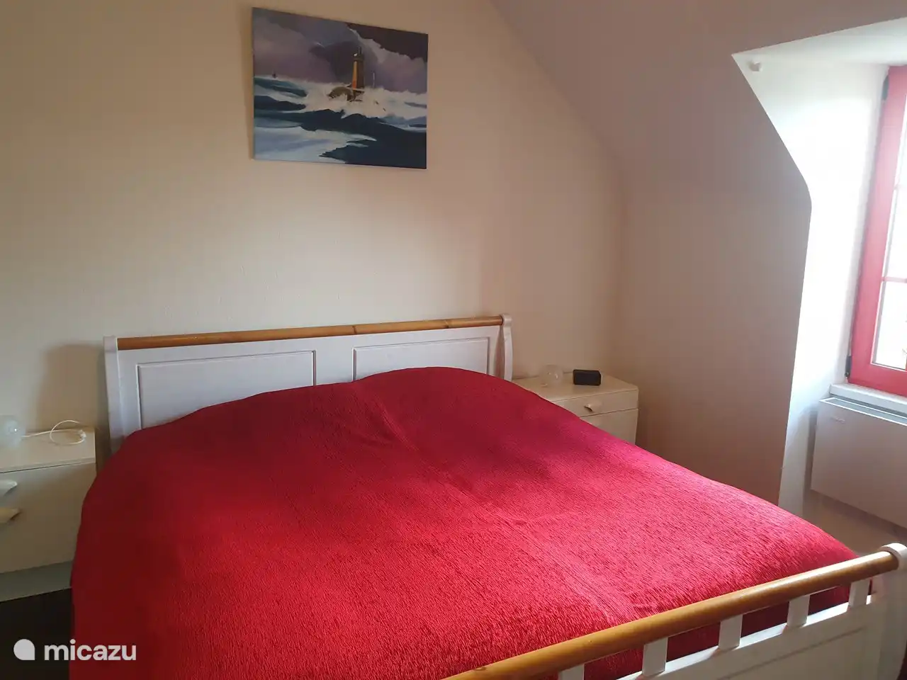 Bedroom with a double bed. The bedroom has a large wardrobe with 4 sliding doors.