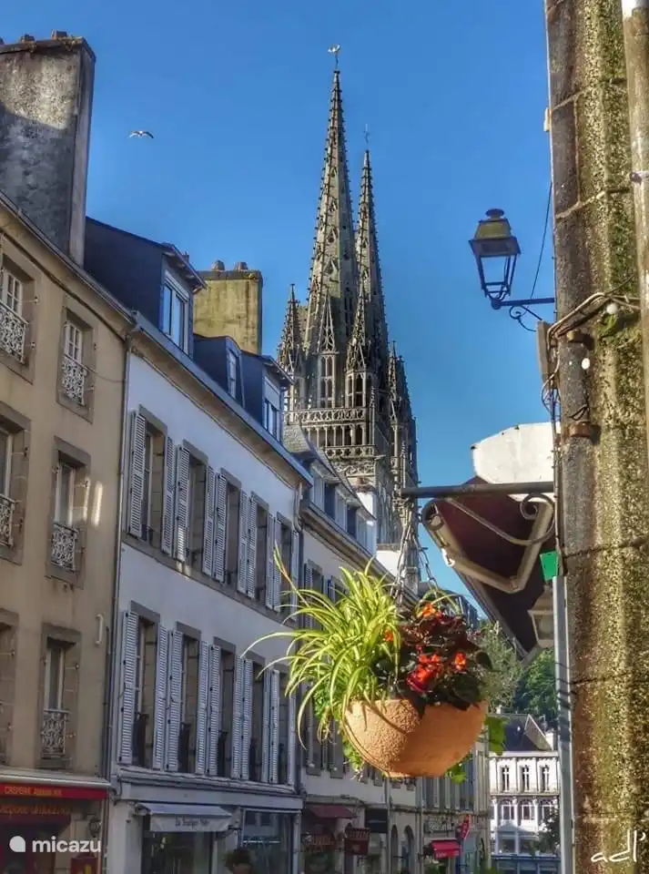 Quimper, capital of the old Breton county of Cornouaille with the imposing cathedral of St. Corentin in the background. In the park behind the cathedral are remains of the old city walls.