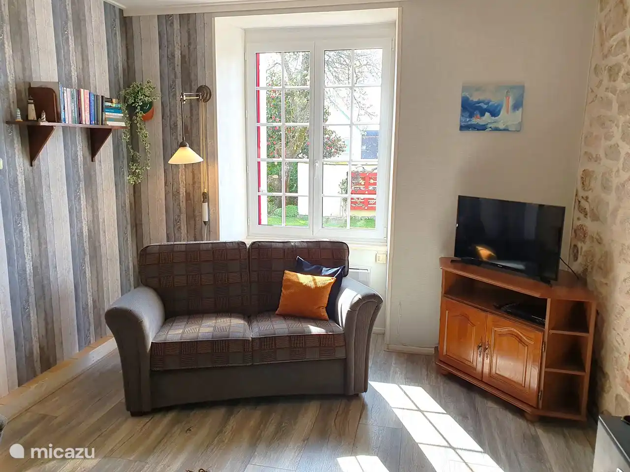 The living room, taken from another corner of the room. Here is a TV with DVD player. The TV is equipped with a google chrome