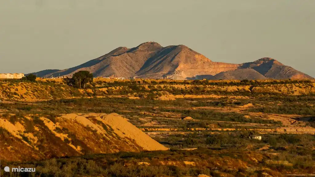 Uitzicht vanaf het dakterras de zon is bijna onder