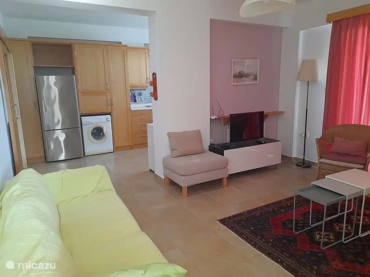 View into the living room and then the kitchen.