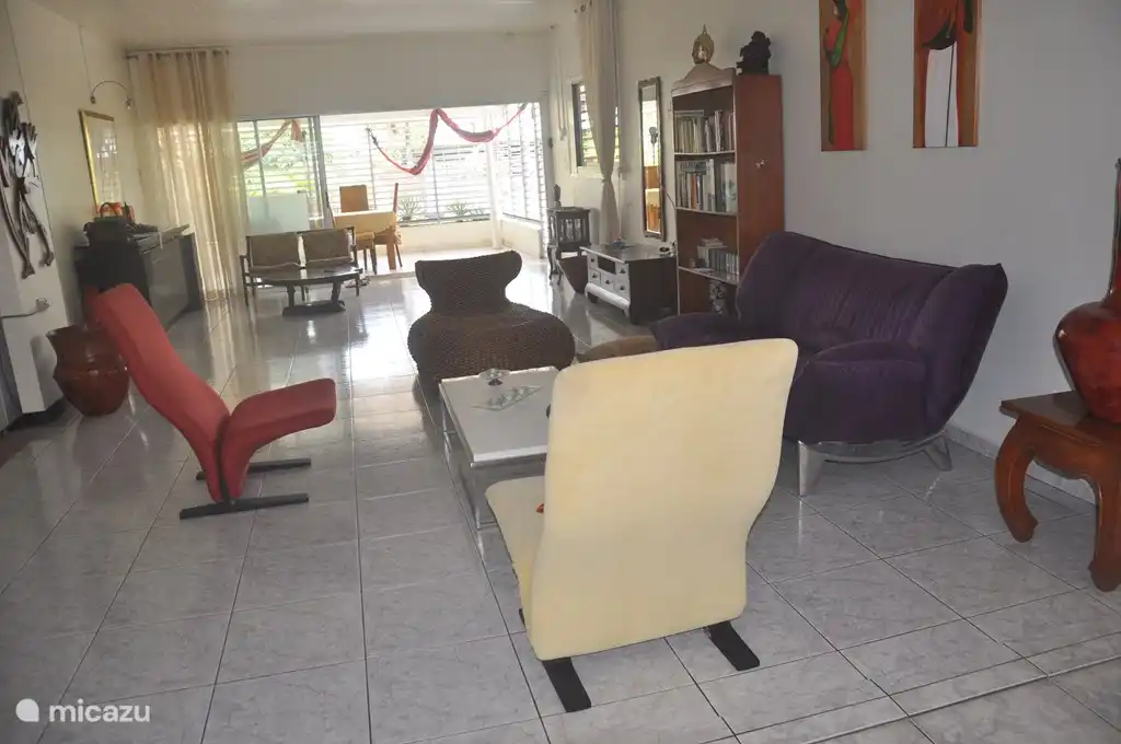 Here's another view of the room from the back entrance. The three rooms that come together: the living room, dining room and kitchen. The living room opens onto the terrace again.