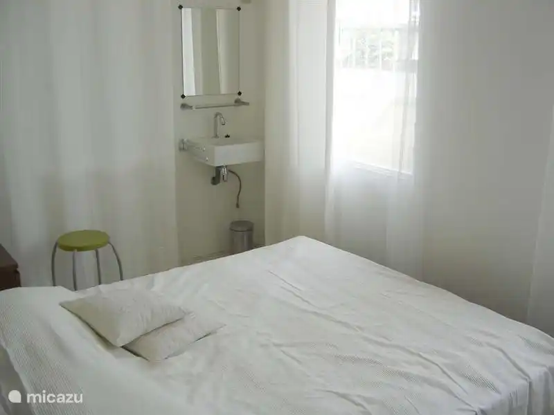 master bedroom with air conditioning, equipped with modern sink and mirror with lights