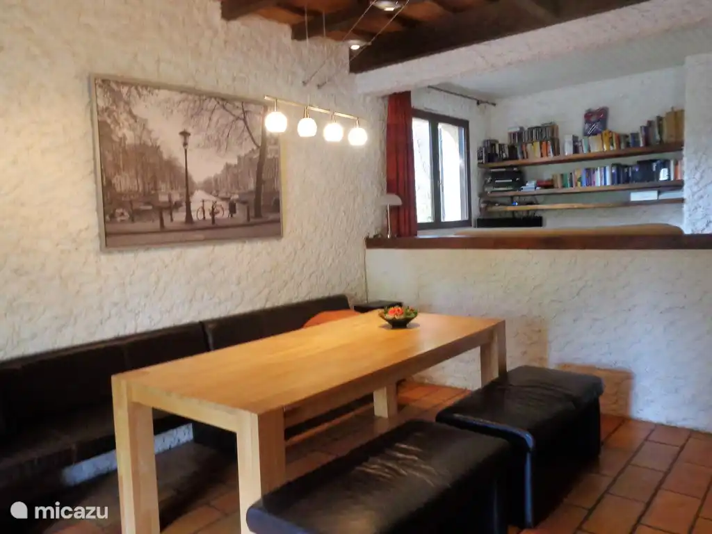 Dining area with TV/reading area behind it.