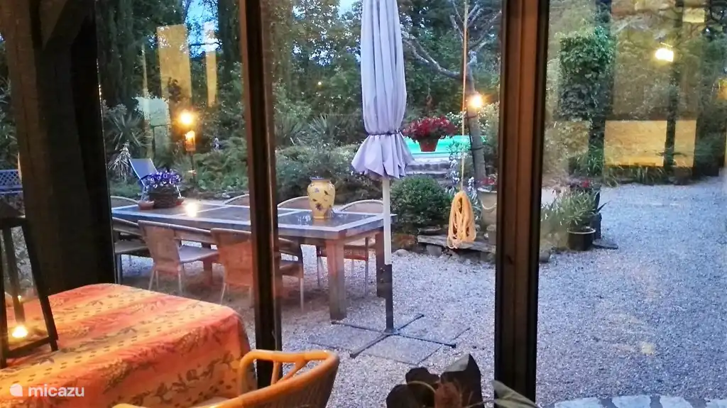 The south-facing conservatory overlooking the garden and pool.