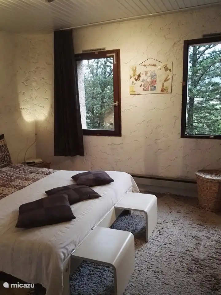 Large bedroom with views over the vineyards and mountains.