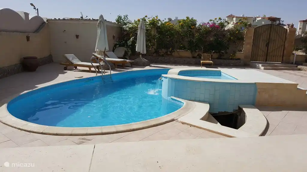 The swimming pool with waterfall
