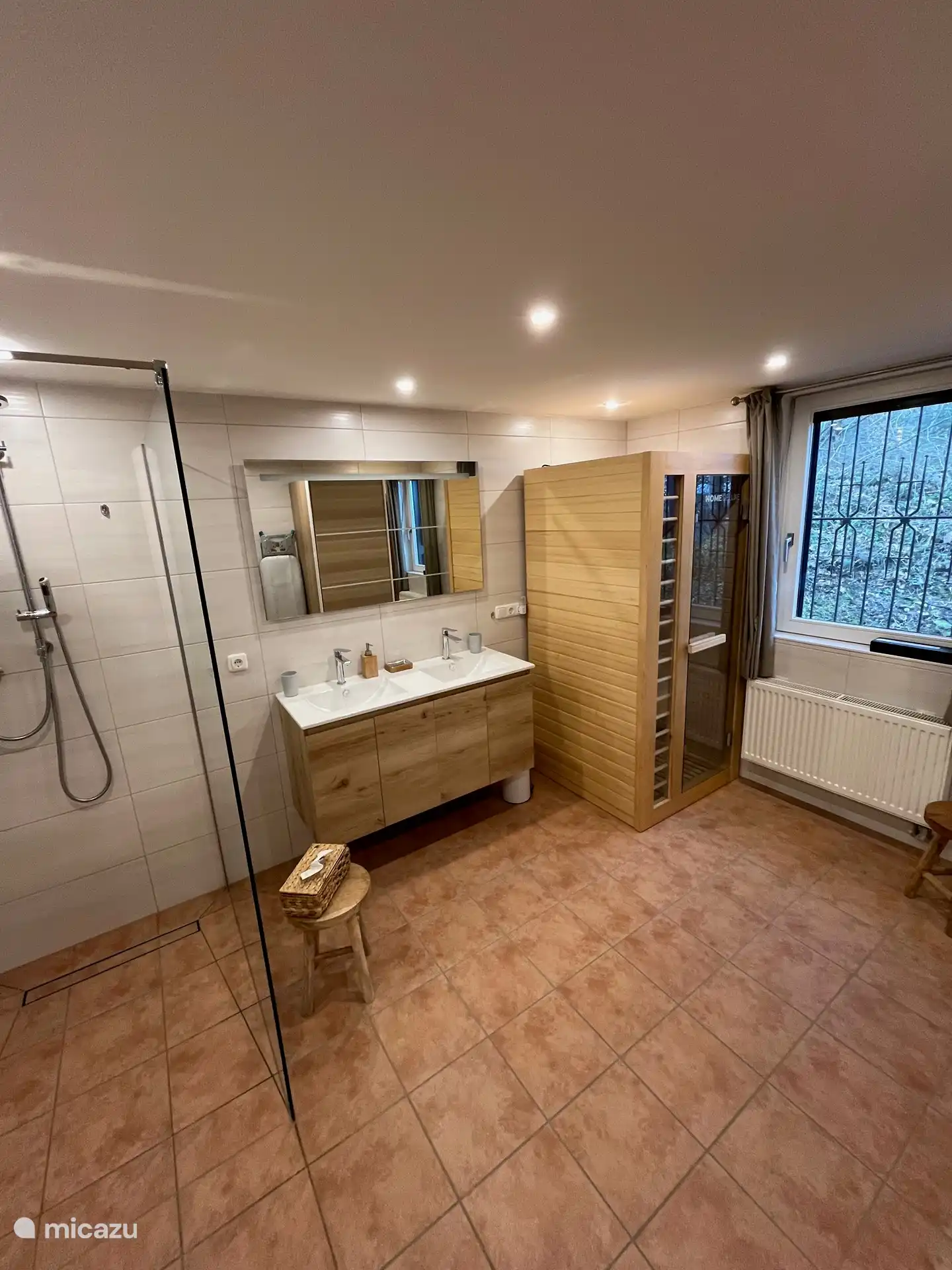 Bathroom, this is equipped with toilet, double sink, walk-in shower and infrared sauna
