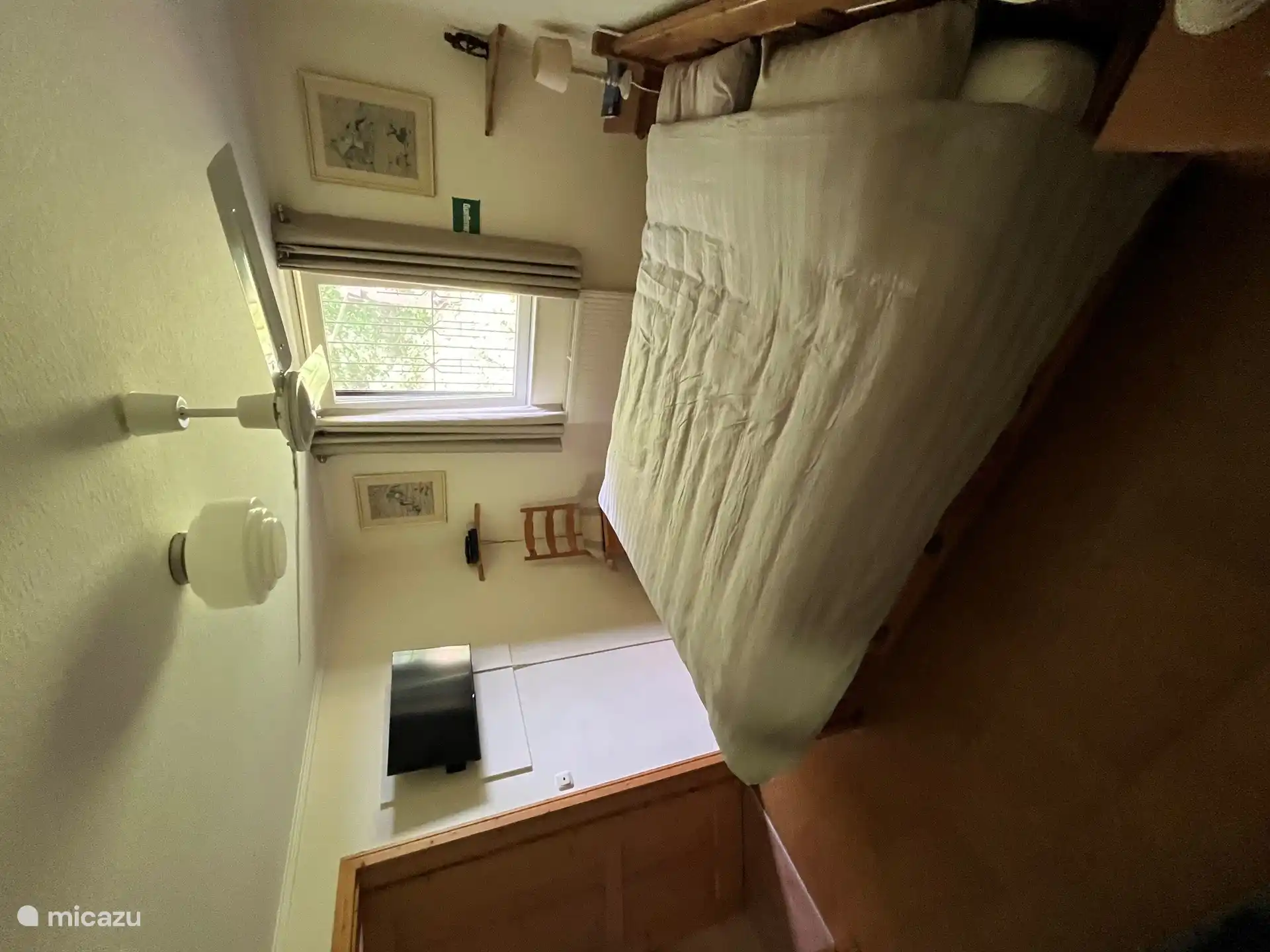 Bedroom has a large double bed and TV