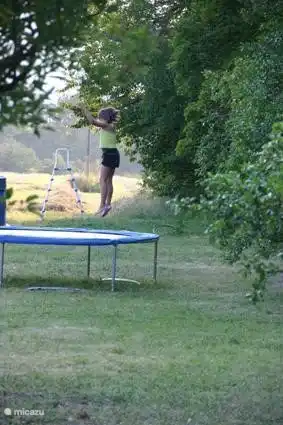 schönen Sprung auf dem Trampolin im Garten