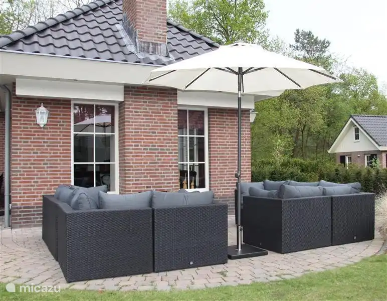 10-person accommodation with lounge set and outdoor fireplace.