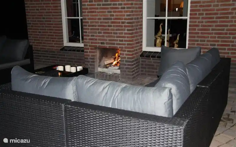 Relax on the lounge set by the outdoor fireplace.