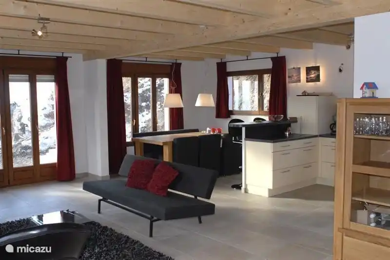 Modern living room with patio doors to the balcony and upper terrace