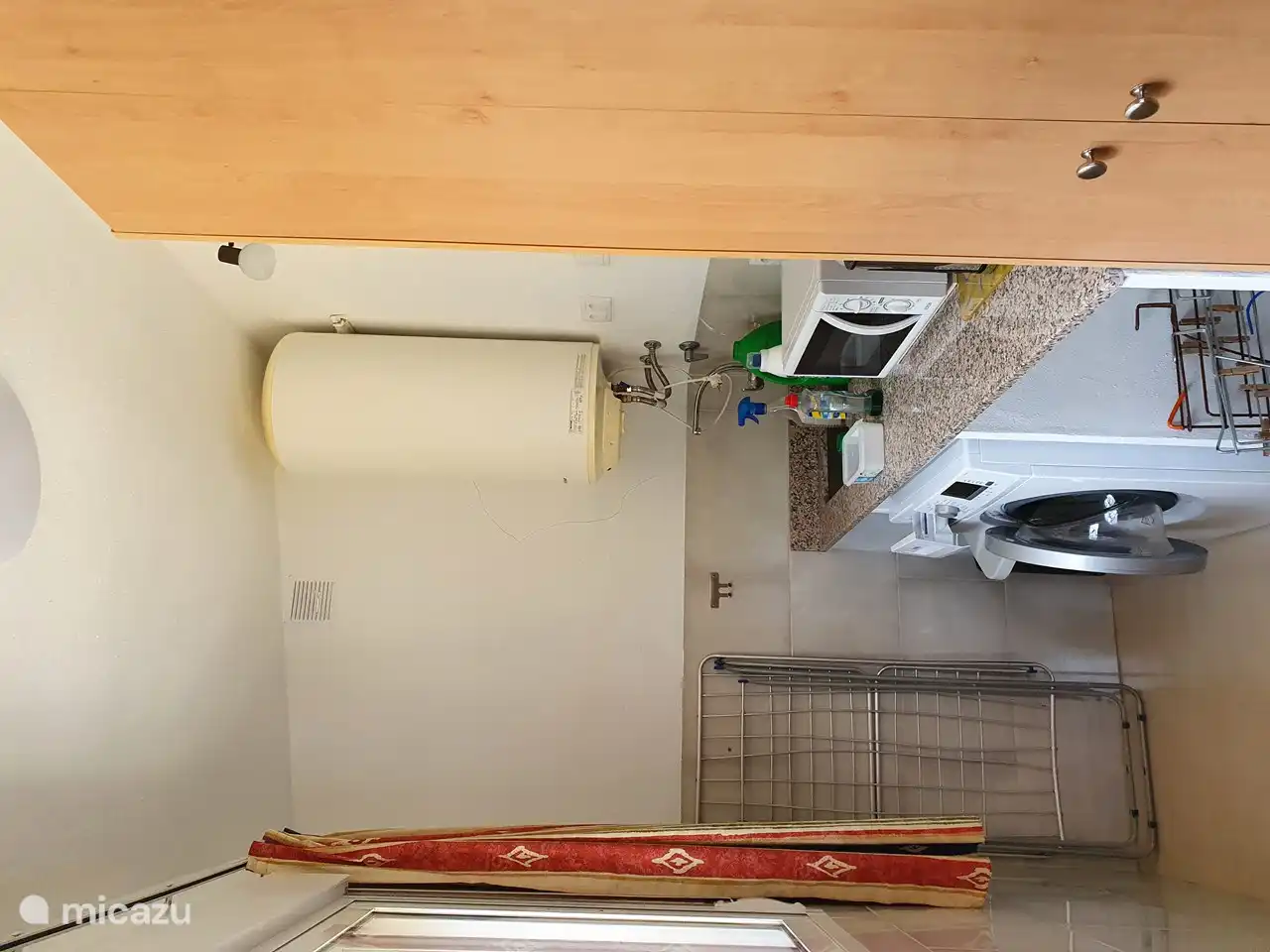 Utility room with extra worktop, sink, boiler, washing machine, microwave, Senseo, kettle, toaster and spacious cupboard, spacious sliding windows.