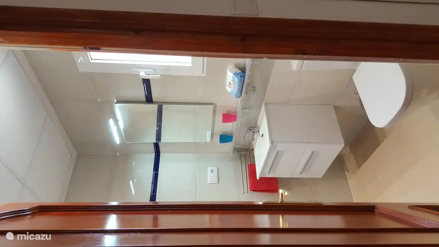 2nd bathroom with toilet, sink, spacious shelf, this bathroom is adjacent to the 3rd bedroom