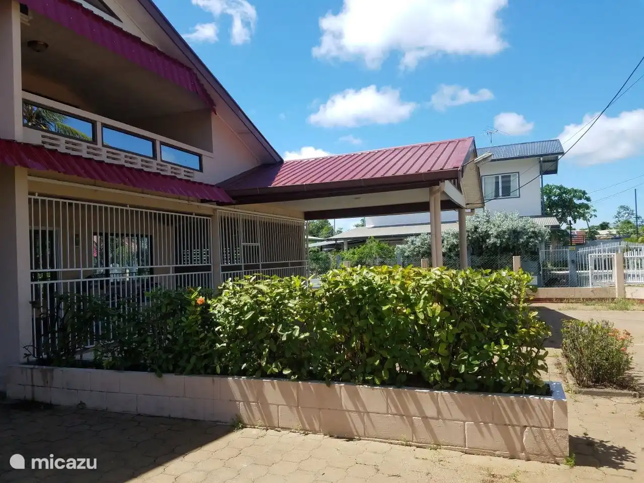 Maison B avec les voisins en arrière-plan.