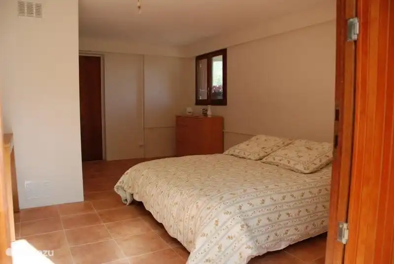 The third large bedroom on the ground floor with a door to the outside. This room has one double and one single bed.