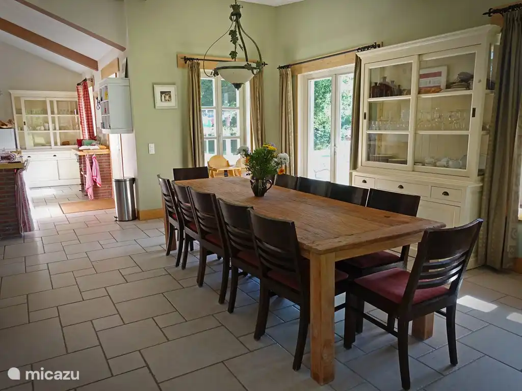 Salle à manger pour 12 personnes, 2 chaises hautes à disposition. Cuisine spacieusement équipée avec plaques électriques, lave-vaisselle, micro-ondes combiné.