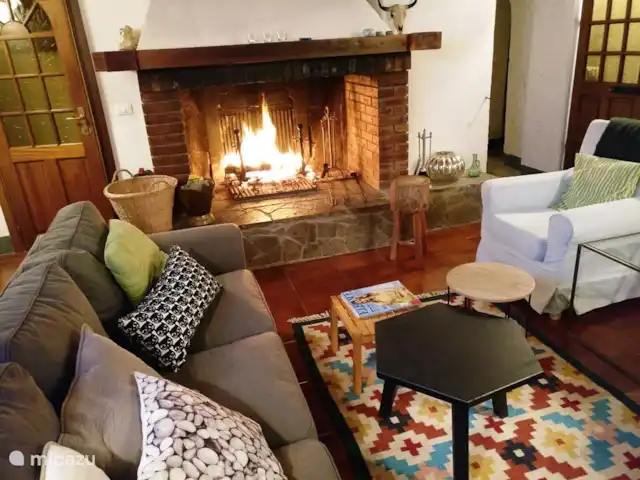 Casa al Pino | Italie, Toscane, Riparbella - maison de vacances Séjour / salon de Casa al Pino avec cheminée. La maison dispose de 2 coins salon, un près de la cheminée et de la télévision par satellite et un à côté avec un canapé d'angle, pour lire un livre ou pour les enfants .....