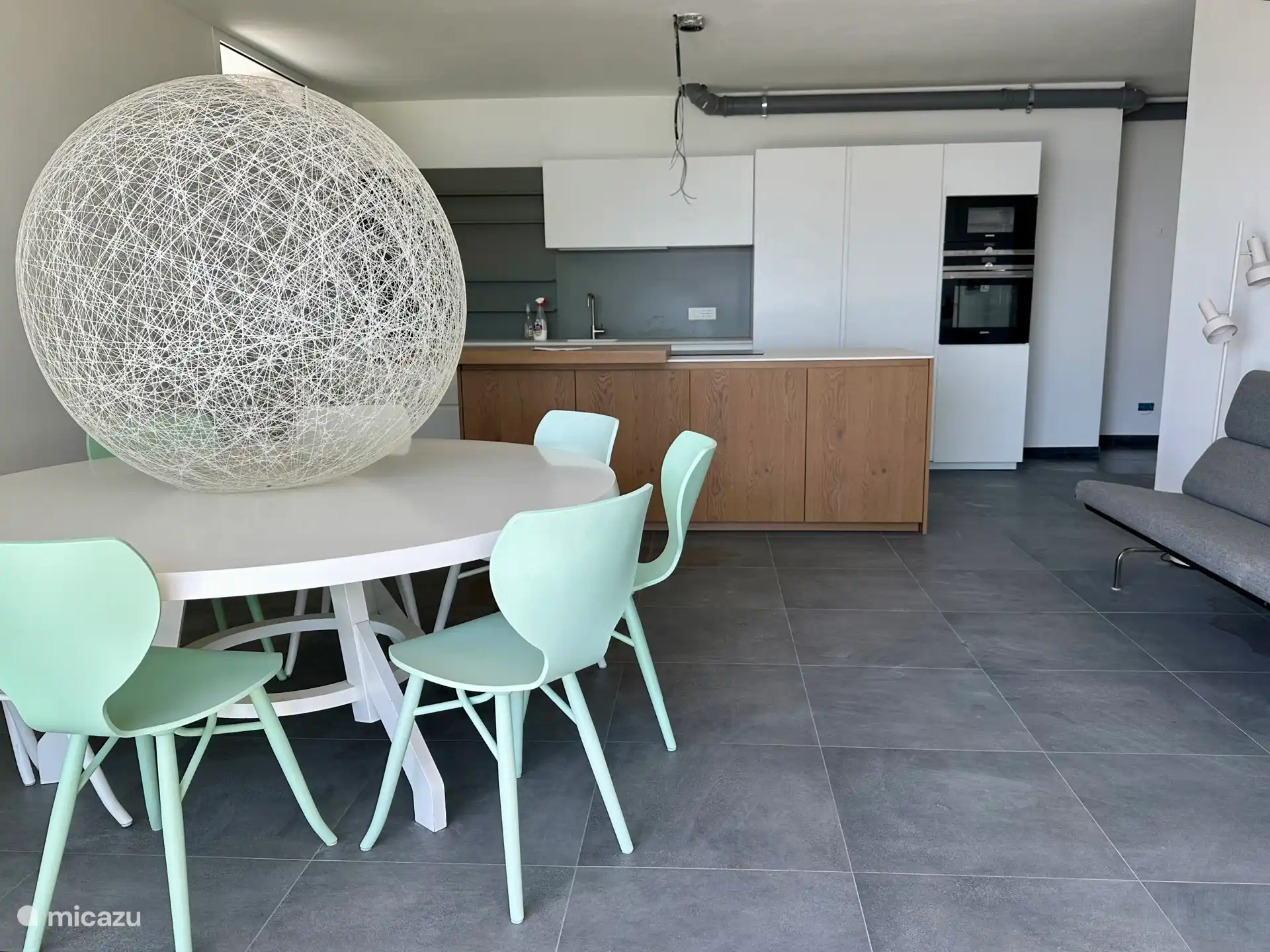Our new kitchen with dining table and 8 chairs, a bench and patio doors to the terrace (there are still some work to be done on the kitchen, but this already gives an impression).